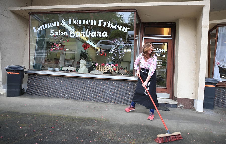 Hairdresser Barbara Hoppe prepares her shop for the reopening next week, as the spread of coronavirus disease (COVID-19) continues in Bonn. Reuters