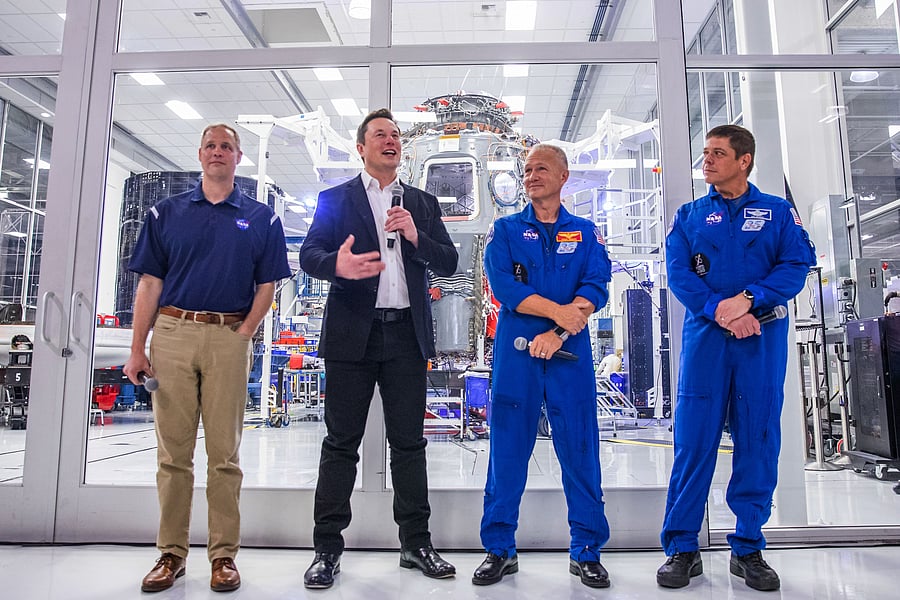 SpaceX founder Elon Musk (2nd L) addresses the media alongside NASA Administrator Jim Bridenstine (L), and astronauts Douglas Hurley (2nd R) and Robert Behnken (R), during a press conference announcing new developments of the Crew Dragon reusable spacecraft, at SpaceX headquarters in Hawthorne, California. (Credit: AFP)
