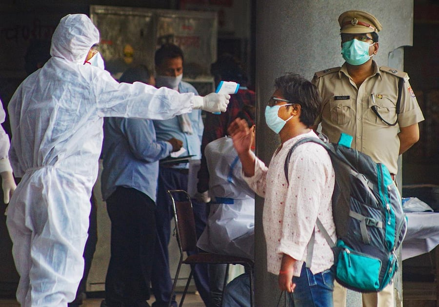 Students who were stranded in Kota due to nationwide lockdown undergo thermal screening after arriving by Delhi Transport Corporation (DTC) buses, at Kashmere Gate ISBT in New Delhi, Sunday, May 03, 2020. Credit: PTI Photo