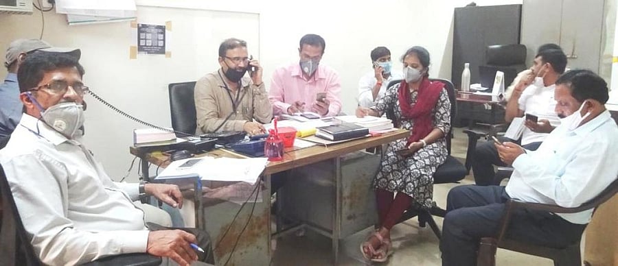 Officials take part in a phone-in programme organised at the DC's office in Madikeri on Monday. DH photo