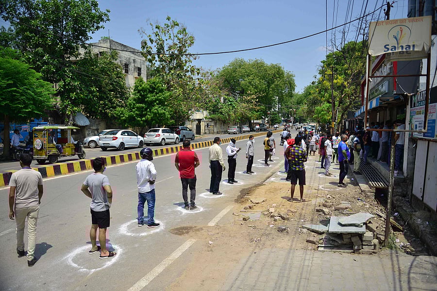 People line up to buy alcohol outside a liquor shop after the government eased a nationwide lockdown. (Credit: AFP Photo)