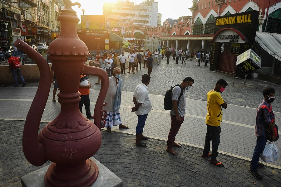 People wait in a queue outside a liquor shop to buy alcohol after the government eased a nationwide lockdown imposed as a preventive measure against the COVID-19 coronavirus. (AFP Photo)
