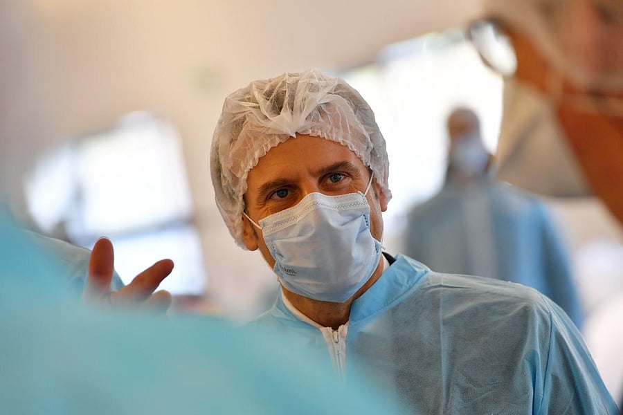French President Emmanuel Macron wearing protective suit and face mask visits the Kolmi-Hopen protective face masks factory in Saint-Barthelemy-d'Anjou near Angers, central France, amid a novel coronavirus (COVID-19) pandemic. Credit: AFP Photo