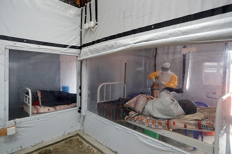 Moise Vaghemi, 33, a father of two children and an Ebola survivor who works as a nurse, tends to a patient who is suspected to be suffering from Ebola, inside the Biosecure Emergency Care Unit (CUBE) at an Ebola treatment centre (ETC) in Katwa, near Butembo, in the Democratic Republic of Congo. (Reuters Photo)