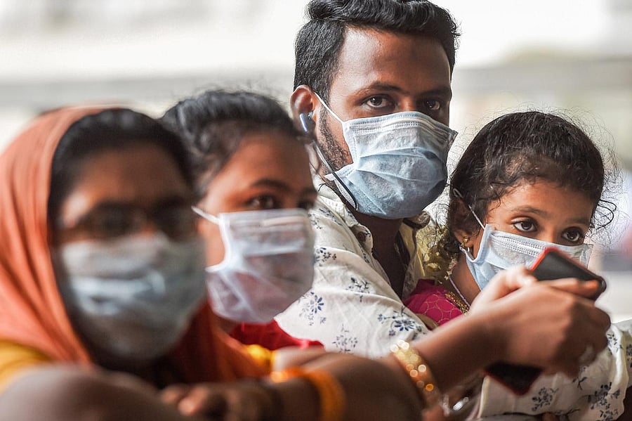 Passengers wear protective masks, in wake of the deadly novel coronavirus, at the airport in Chennai, Friday, March 6, 2020. (PTI Photo)