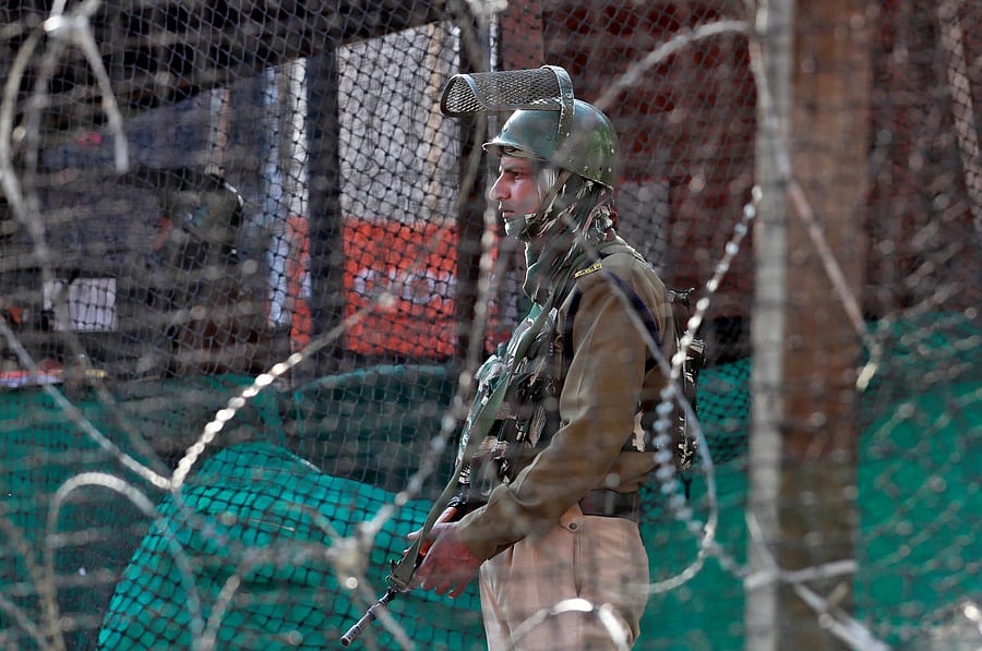 An Indian policeman stands guard outside a bunker alongside a road in Srinagar. Credit: Reuters File Photo