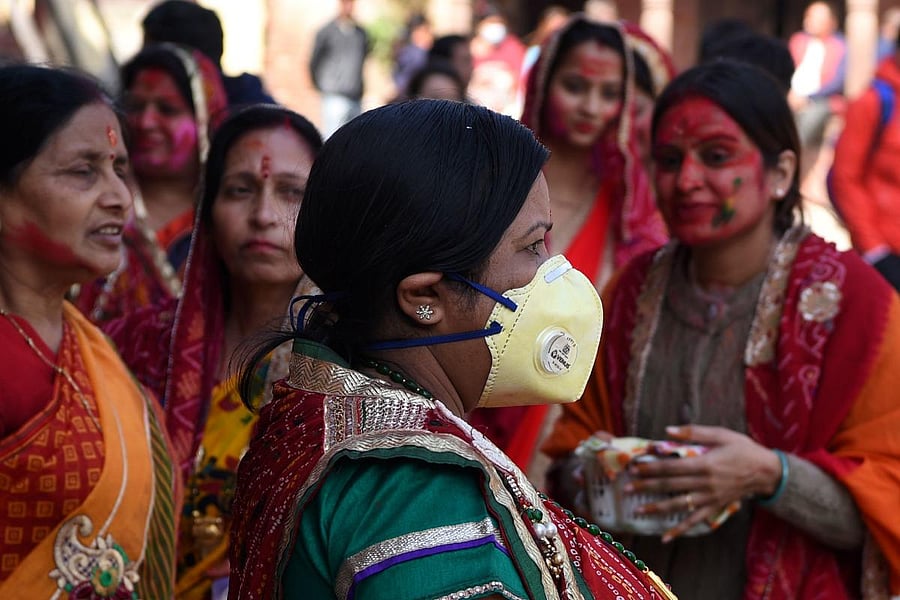 A reveller wearing a facemask amid fears of the spread of COVID-19 novel coronavirus, arrives to celebrate Holi, the spring festival of colours, in Kathmandu on March 9, 2020. (AFP Photo)