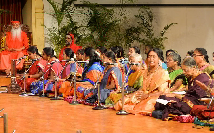 Ganapathy Sachchidananda Swami and devotees render keertanas as part of Tyagaraja Aradhana, organised on account of Mahashivaratri, at Avadhoota Datta Peetha, in Mysuru (DH Photo)