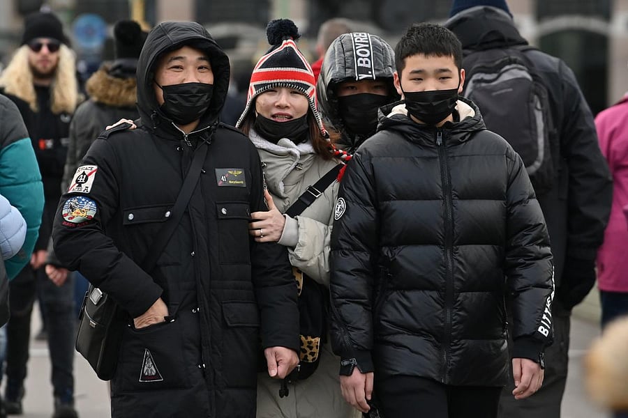 Pedestrians wear face masks as they walk in central London on January 28, 2020. AFP