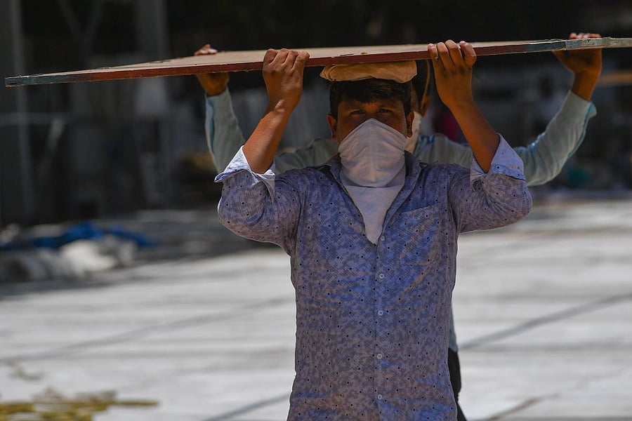Workers set up an isolation centre during a nationwide lockdown to fight the spread of the COVID-19 coronavirus, in Mumbai. AFP