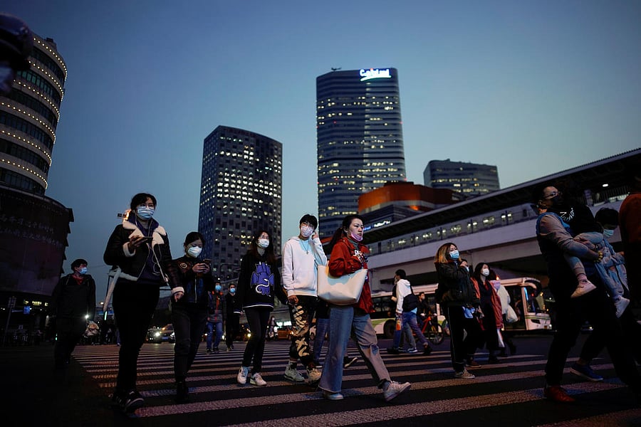 People wearing protective face masks are seen on a crossroad following the outbreak of coronavirus disease (COVID-19) in China (Reuters Photo)