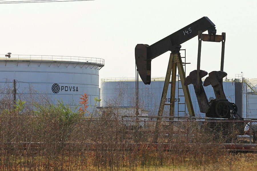 An oil pumpjack and a tank with the corporate logo of state oil company PDVSA are seen in an oil facility in Lagunillas, Venezuela January 29, 2019. (REUTERS)