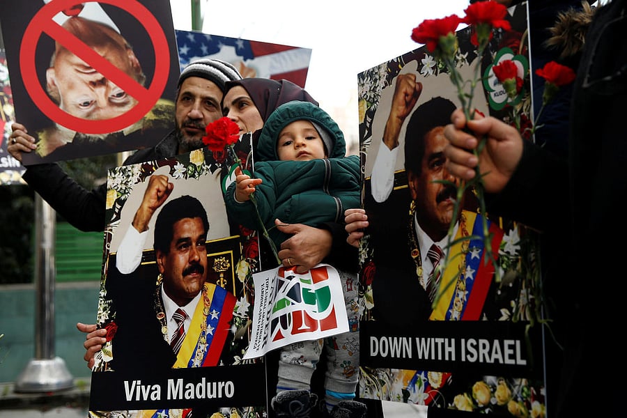 Protesters hold banners as they gather in support of Venezuelan President Nicolas Maduro's government in front of the Venezuelan Consulate in Istanbul. Reuters