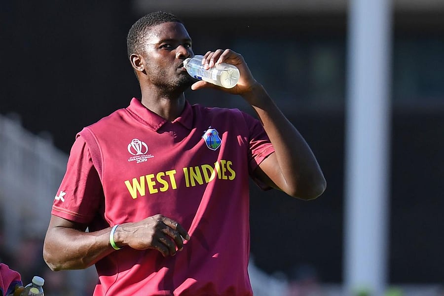 West Indies' captain Jason Holder takes a drink during a break in play in the 2019 Cricket World Cup group stage match between Australia and West Indies at Trent Bridge in Nottingham, central England, on June 6, 2019. - Australia beat West Indies by 15 ru