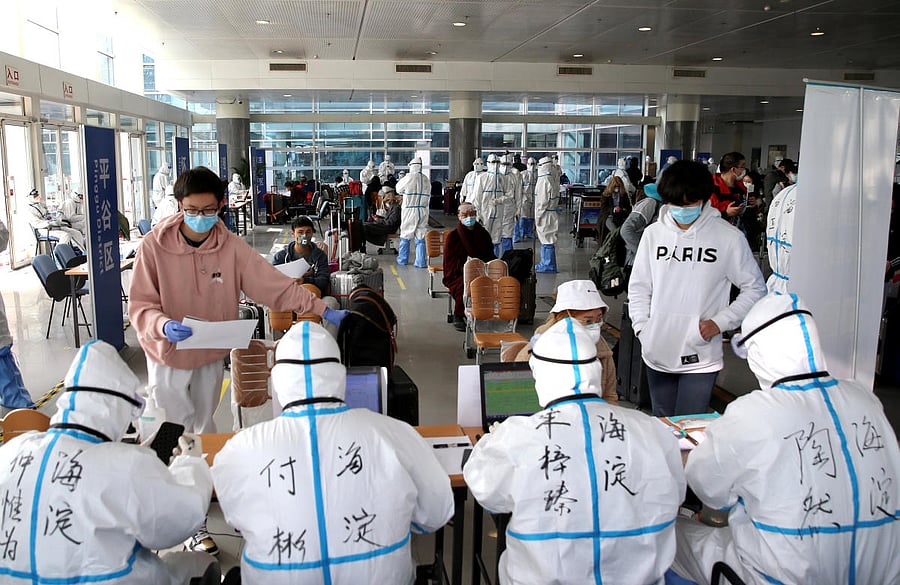 Passengers register their information at the New China International Exhibition Center, a transit hub to screen incoming passengers from the Beijing Capital International Airport for COVID-19, caused by the coronavirus, in Beijing, China March 18, 2020. (