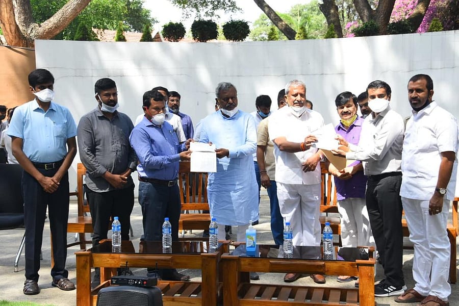 Ministers S T Somashekar and B A Basavaraj hand over cheques to Zoo Authority of Karnataka Member Secretary B P Ravi and Mysuru Zoo Director Ajit Kulkarni on Thursday. Deputy Commissioner Abhiram G Sankar, MP Pratap Simha and MLAs S A Ramdas and L Nagendr