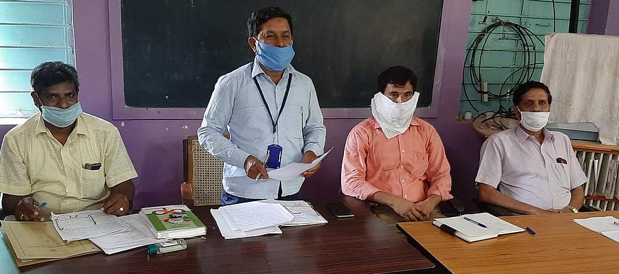 Block Education Officer K S Nagaraj Gowda chairs meeting of headmasters of government and government aided schools in Kolar on Saturday.