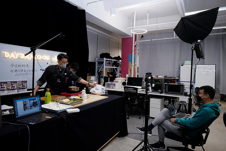 A chef wearing a face mask conducts a cooking lesson through a live-streaming session inside a restaurant at a office as the country is hit by an outbreak of the novel coronavirus that can cause COVID-19 disease, in Shanghai. (Credit: Reuters Photo)