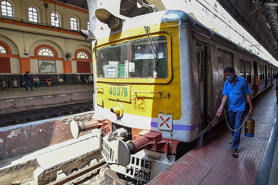  A railway worker disinfects in the wake of coronavirus pandemic, at Sealdah Railway Station in Kolkata, Saturday, March 21, 2020. (PTI Photo)