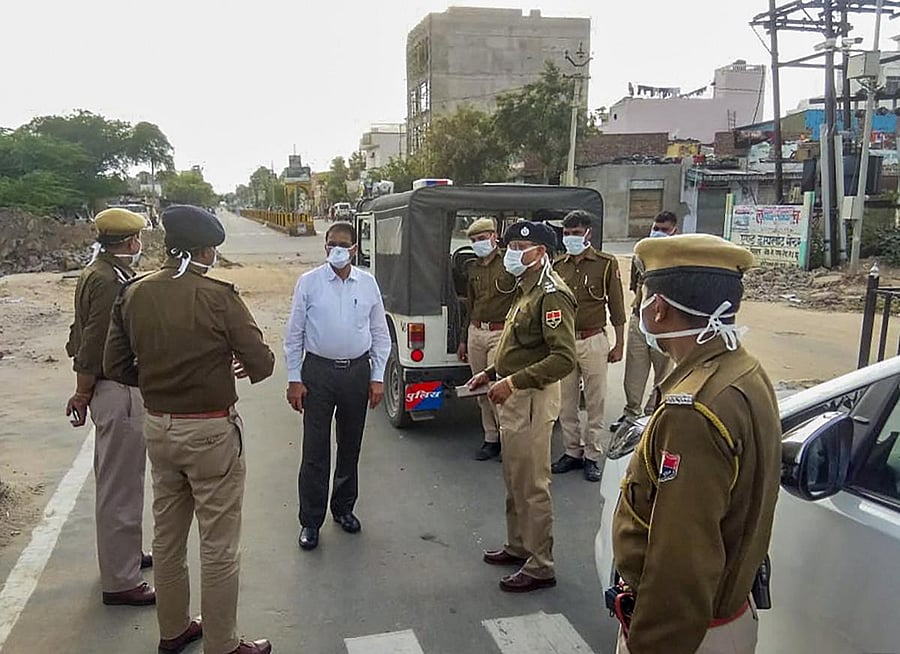 Police personnel wearing masks as a preventive measure against coronavirus pandemic stand guard in Jhunjhunu district of Rajasthan (PTI Photo)