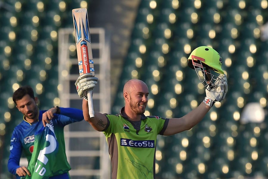 Lahore Qalandars Chris Lynn celebrates after scoring a century (100 runs) during the Pakistan Super League (PSL) T20 cricket match between Lahore Qalandars and Multan Sultans at the Gaddafi Cricket Stadium in Lahore on March 15, 2020. (Photo by Arif ALI /