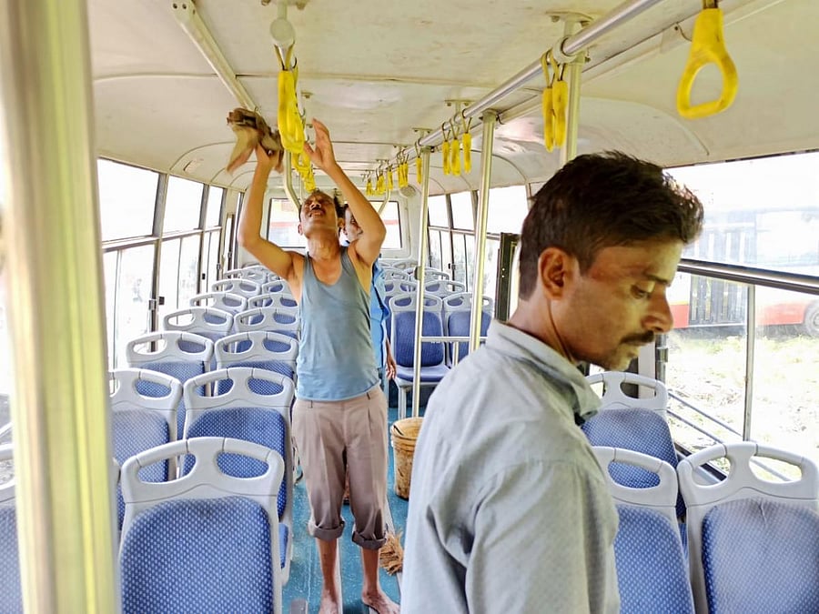 A bus of Assam State Transport Corporation being cleaned as a precautionary measure on Sunday. DH photo