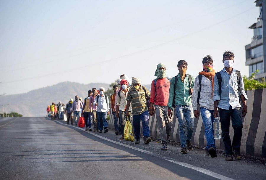 Migrants from Jharkand, who were stranded in Raigad district of Maharashtra, walk along a road towards their native place during the ongoing nationwide COVID-19 lockdown, in Navi Mumbai, Saturday, May 9, 2020. (PTI Photo)
