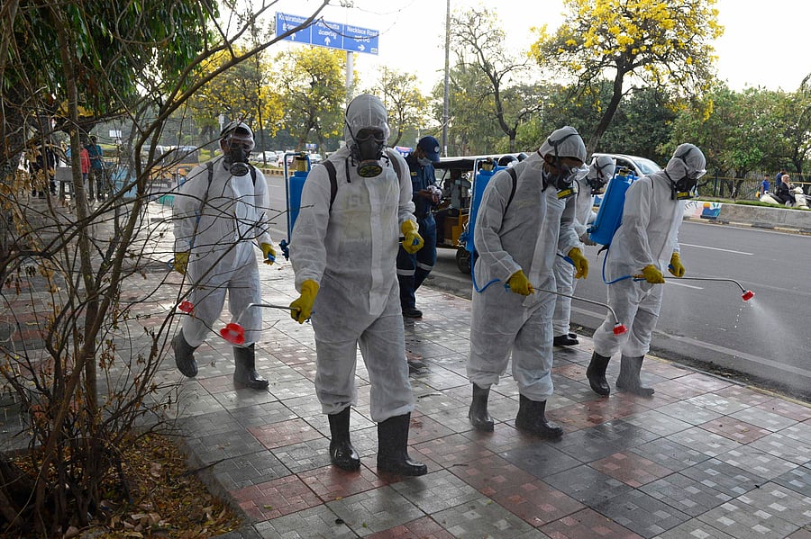 Members from Disaster Response Force (DRF) of Telangana State, wearing protective gear spray disinfectant on a pedestrian footpath amid concerns over the spread of the COVID-19 novel coronavirus. (AFP Photo)