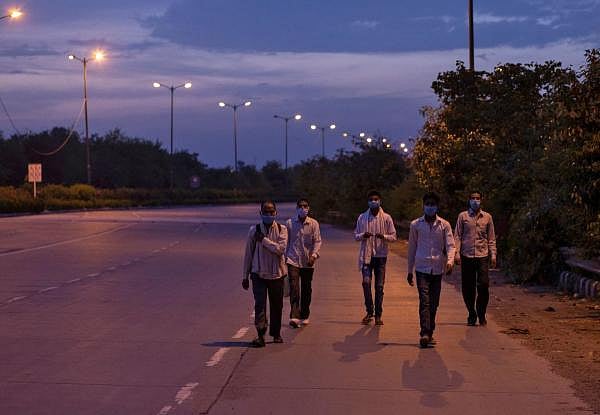 Migrant workers walk along a road to return to their villages, during a 21-day nationwide lockdown to limit the spreading of coronavirus disease, in New Delhi. (Credit: Reuters Photo)