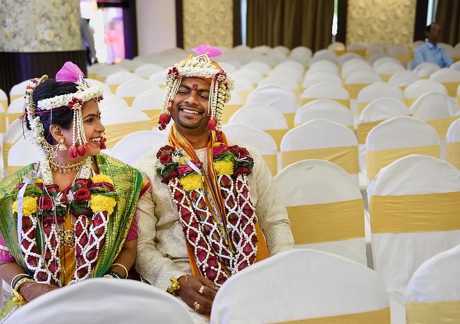 Ruchit Sane (groom) and Akshita Vaidya (bride) share a light moment during their wedding ceremony in Mumbai. (Credit: PTI Photo)