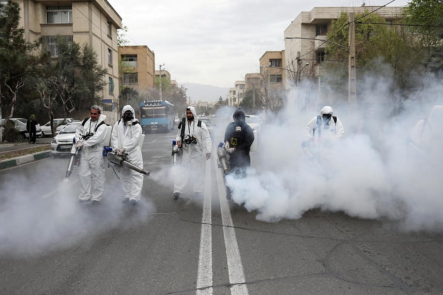 : Members of firefighters wear protective face masks, amid fear of coronavirus disease, as they disinfect the streets, ahead of the Iranian New Year(Reuters Photo)