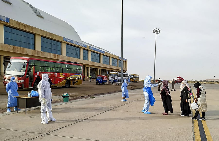 Indian nationals evacuated from Iran undergo a thermal screening test before being quarantined in Indian Army Wellness Facility Centre at Jaisalmer Military Station. Two Air India flights carrying over 230 Indians from coronavirus-hit Iran landed here on Sunday morning. (PTI Photo)