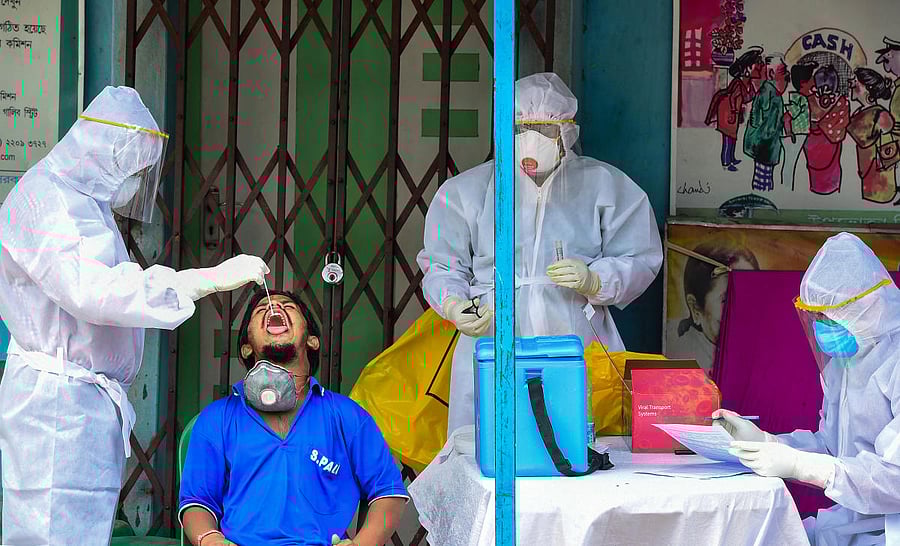 Health workers collect swab sample from a person for COVID-19 test, during ongoing COVID-19 lockdown, in Kolkata, Thursday, May 7, 2020. (PTI Photo)