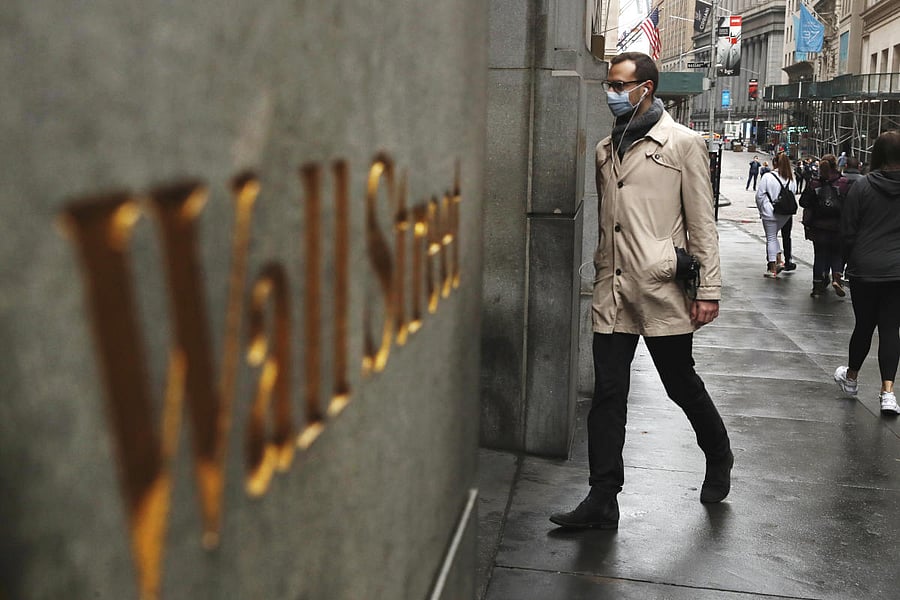 A man wears a protective mask as he walks on Wall Street during the coronavirus outbreak in New York. Credit Reuters File Photo