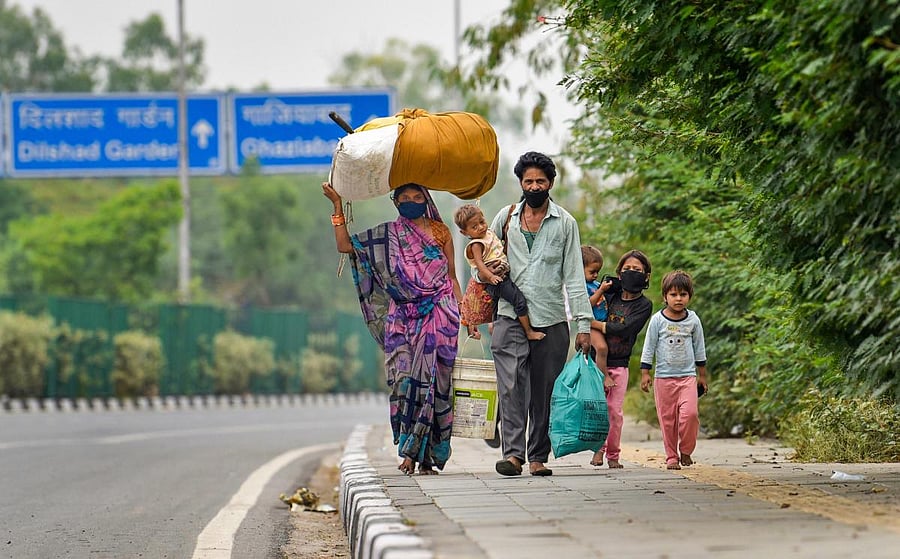 Migrant labourers walking on road (PTI Photo)