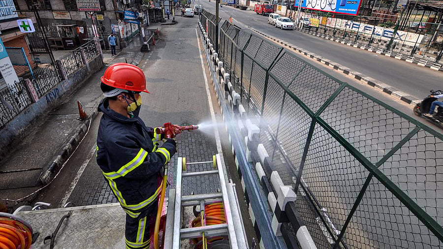 An emergency services worker in Assam sprays disinfectants to combat Covid-19.