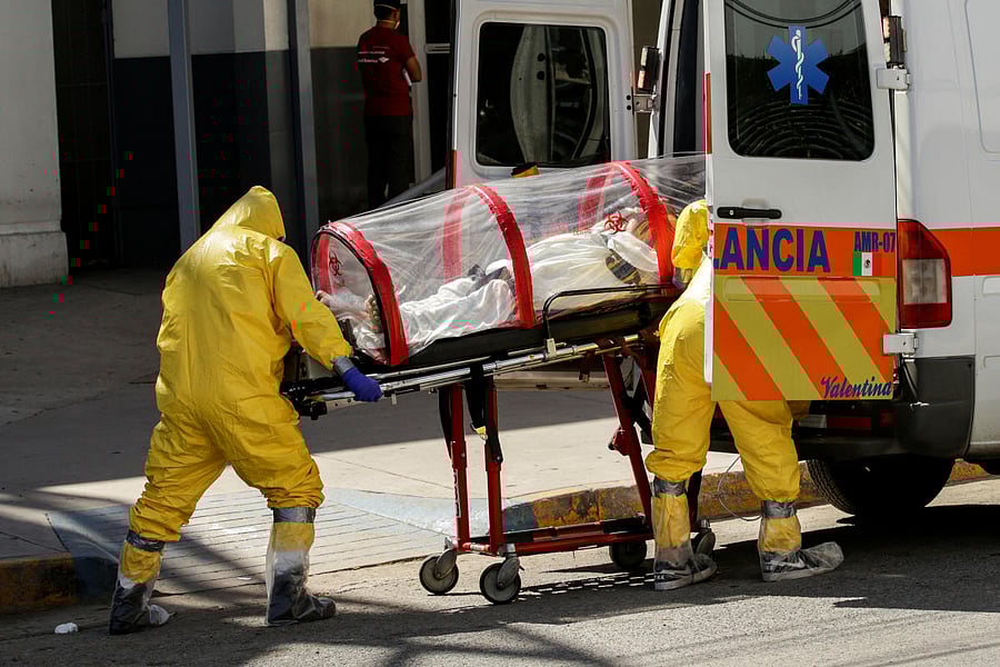 Paramedics move a patient infected with the coronavirus disease (COVID-19) towards an ambulance to transport him to El Paso, Texas, U.S. for treatment, outside the General Hospital in Ciudad Juarez, Mexico May 13, 2020. Credit: Reuters Photo