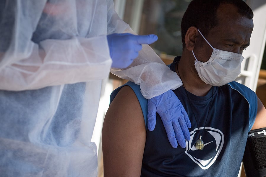 A doctor examines a migrant infected with the novel coronavirus COVID-19 in France. (Credit: Reuters)