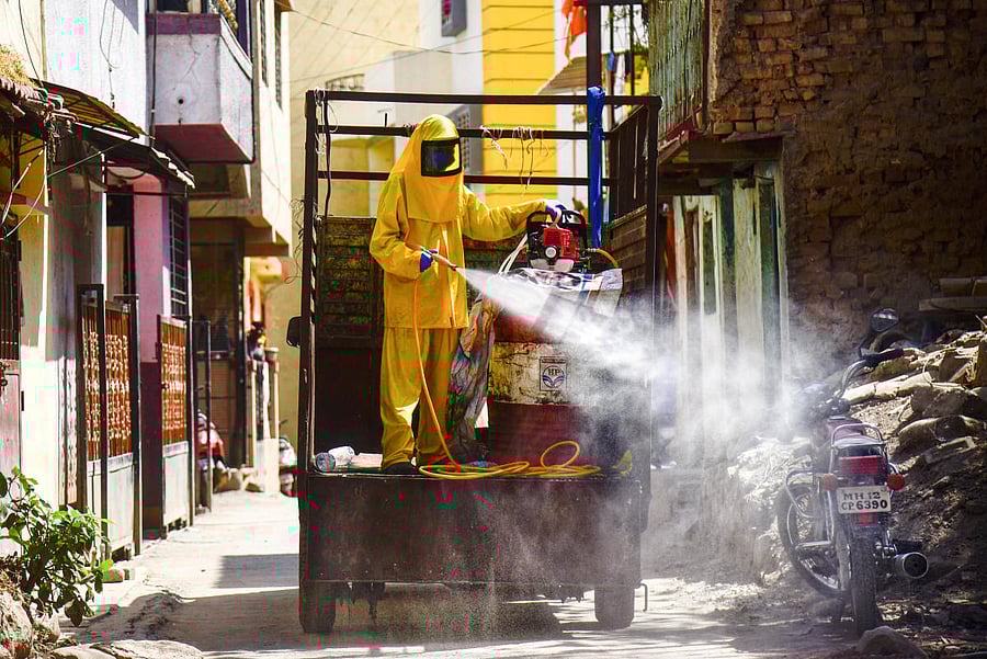 Workers spray disinfectant in a residential area to contain the spread of coronavirus, at Bavdhan in Pune city, Monday, March 23, 2020. (PTI Photo)