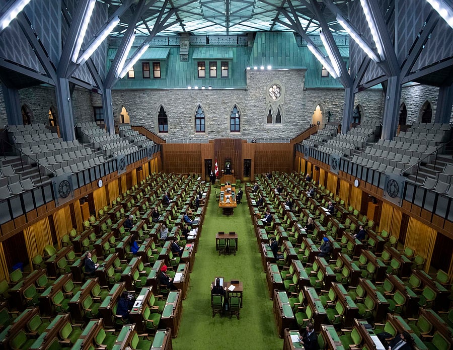 Members of Parliament, attending in limited numbers and seated apart to practice social distancing, wait for proceedings to begin in the House of Commons on Parliament Hill in Ottawa. (AP Photo)