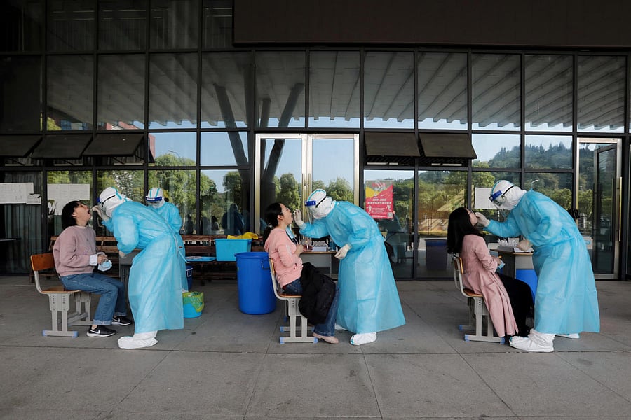Medical workers from a hospital collect swabs from high school teachers for nucleic acid tests at a school, following the coronavirus disease (COVID-19) outbreak, in Yichang, Hubei province, China April 27, 2020. Credit: Reuters Photo