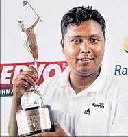 Numero uno: Ashok Kumar displays his silverware after winning the Global Green Bangalore Open at the Karnataka Golf Association in Bangalore on Saturday. DH Photo