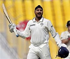 Unyielding Warrior: Harbhajan Singh lets out a roar after completing his hundred against New Zealand on the final day of the first Test at Ahmedabad on Monday. AP