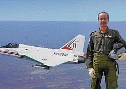 Retired Wg Com Rajiv Kothiyal with LCA Tejas in the background.