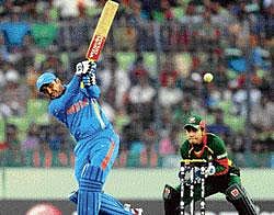 Swashbuckling innings: Virendra Sehwag hits a six as Bangladesh wicketkeeper Mushfiqur Rahim looks on during the first match in the World Cup Cricket tournament between Bangladesh and India at the Sher-e Bangla National Stadium in Dhaka on Saturday. AFP