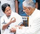 Trinamool Congress party leader Mamata Banerjee, center, takes the oath of office, as Governor M.K. Narayanan, left, looks on in Kolkata, India, Friday, May 20, 2011. AP