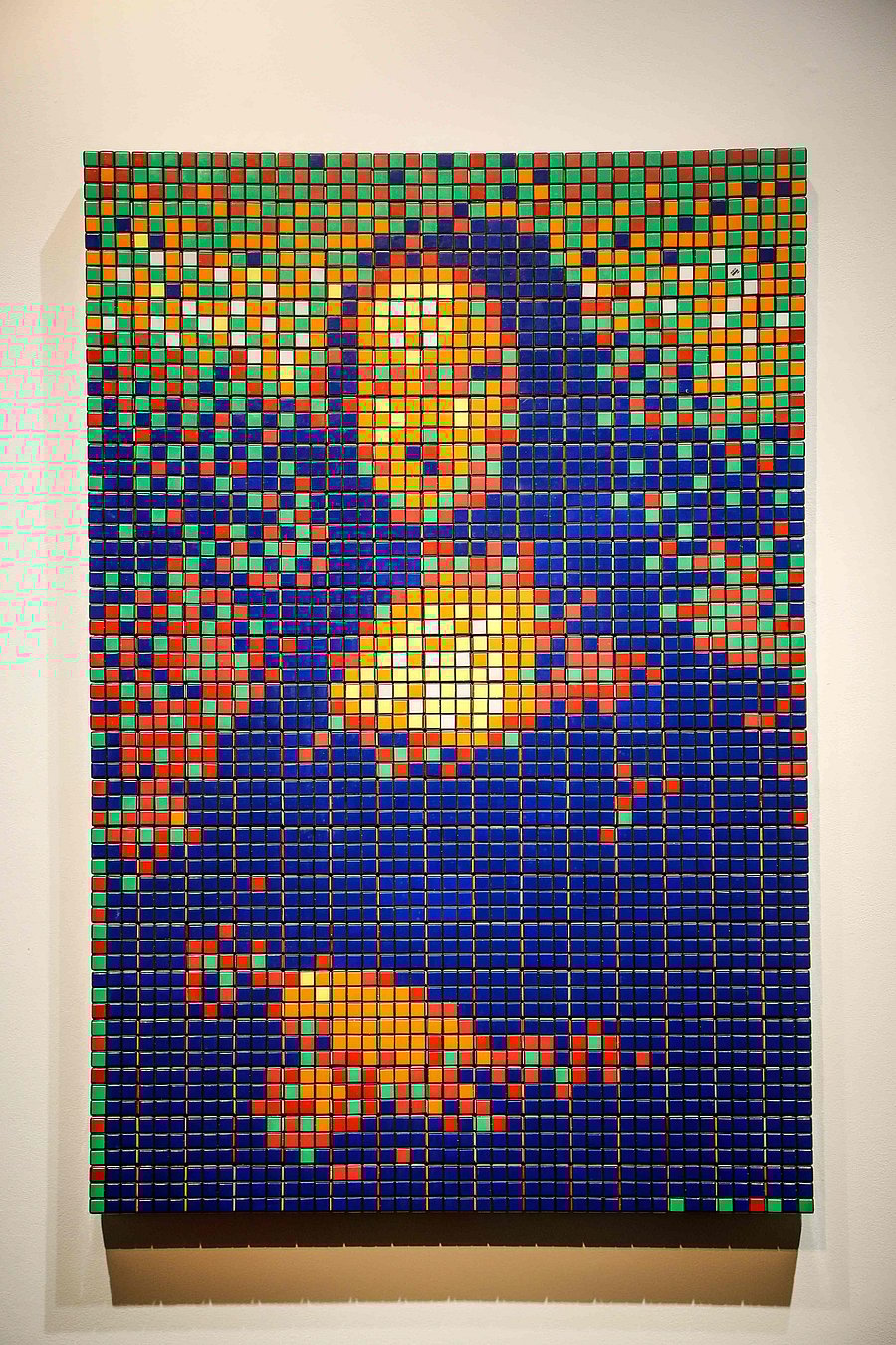 It uses the plastic puzzles' squares to create a mosaic of the Mona Lisa and her famous smile in garish colours. (Credit: AFP Photo)