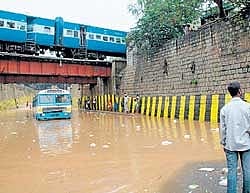 Messy situation: A BMTC bus stuck in rain water under the bridge near Kino Theatre in  Bangalore on Friday. DH photo