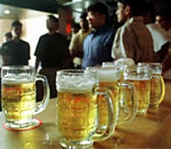 Girls covering their faces after they were detained by the police during a raid at a bar in Pune on Sunday. Around 300 youths were detained by the police and were released later. PTI Photo