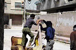 Ready to strike:  Free Syrian Army fighters prepare their weapons in Sidi Meqdad area in the suburbs of Damascus on  Monday. Reuters  photo